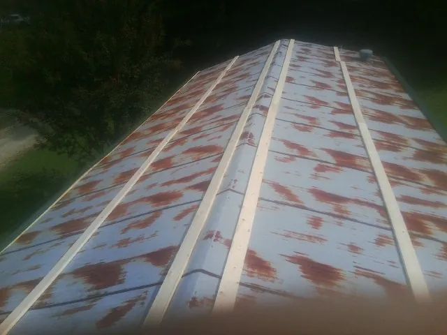 Rusted metal roof panels with new wood purlins before replacement — Storm Damage Roof Repair in Bensalem by Roofing Brothers