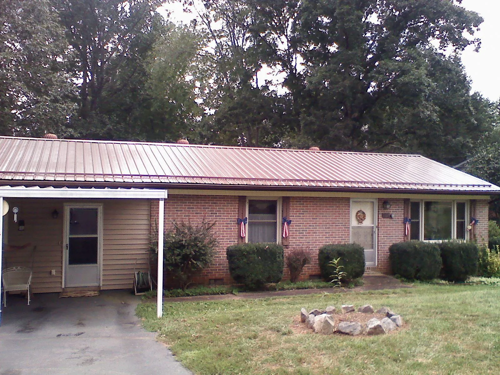 Bronze metal roof and carport on a brick ranch home — Roof Repair work by our crew in Bensalem