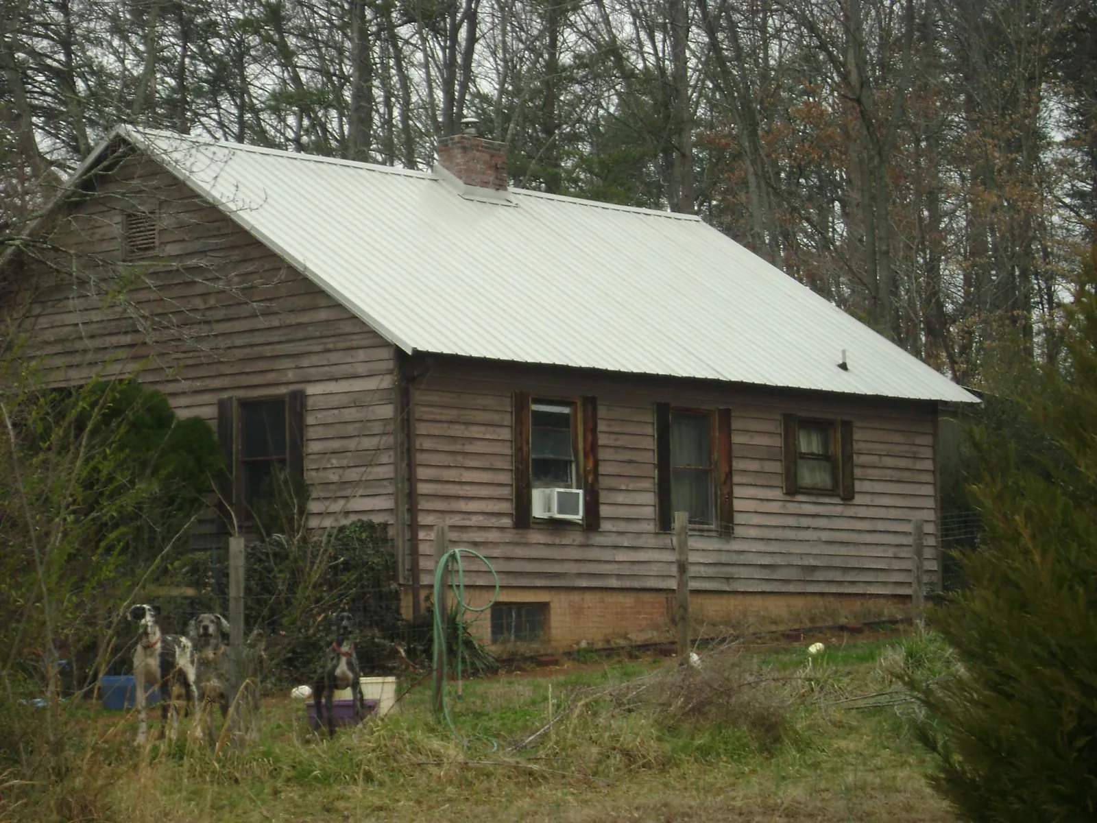 White metal roof on an old wood sided farmhouse, from a Metal Roof Installation job in Bensalem